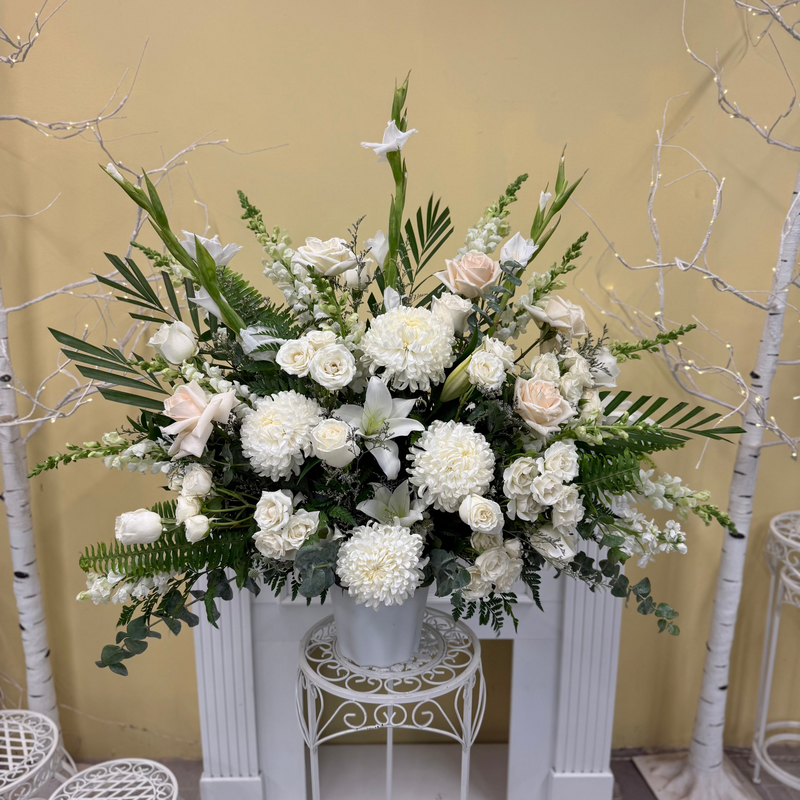 White floral arrangement in a white vase.
