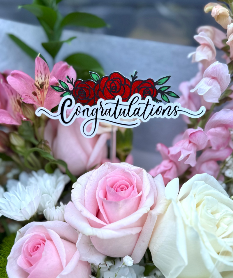 Flower topper sign reading ‘Congratulations’ with floral decoration
