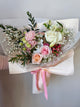 Flower bouquet with white and blush pink flowers, soft baby's breath and light greenery