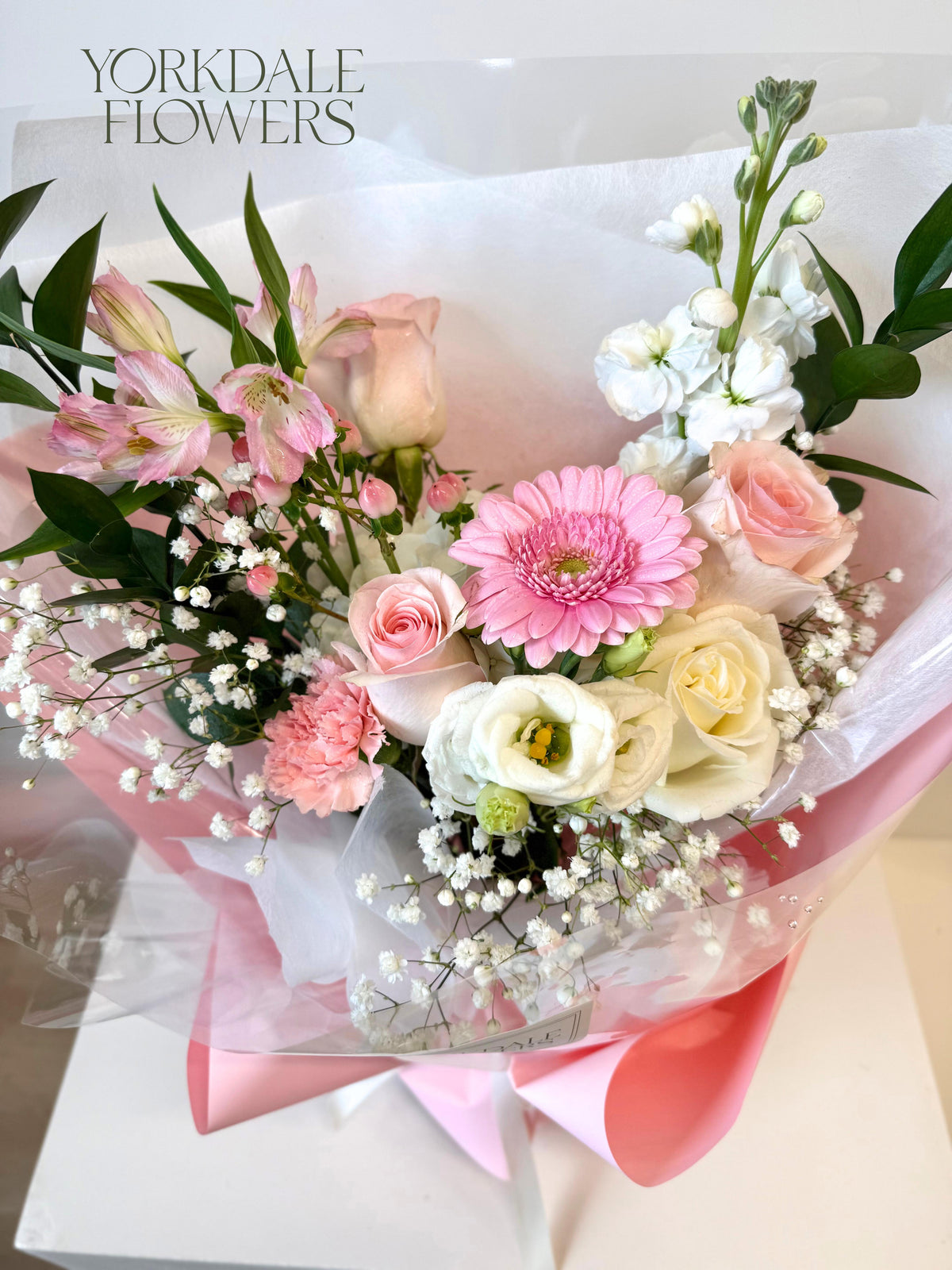 bouquet of light pink and white mixed flowers with light pink wrapping