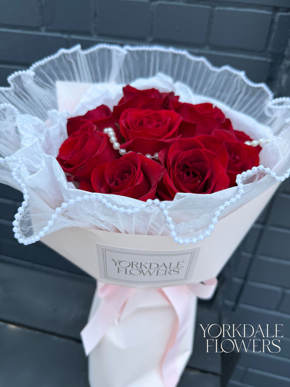Red rose bouquet with pearl detail and pink wrapping