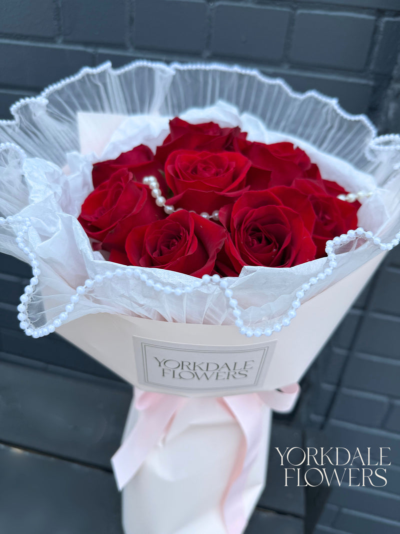 Red rose bouquet with pearl detail and pink wrapping