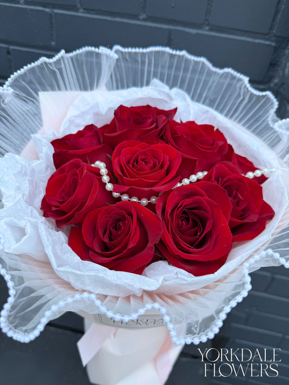 Red rose bouquet with pearl detail and pink wrapping