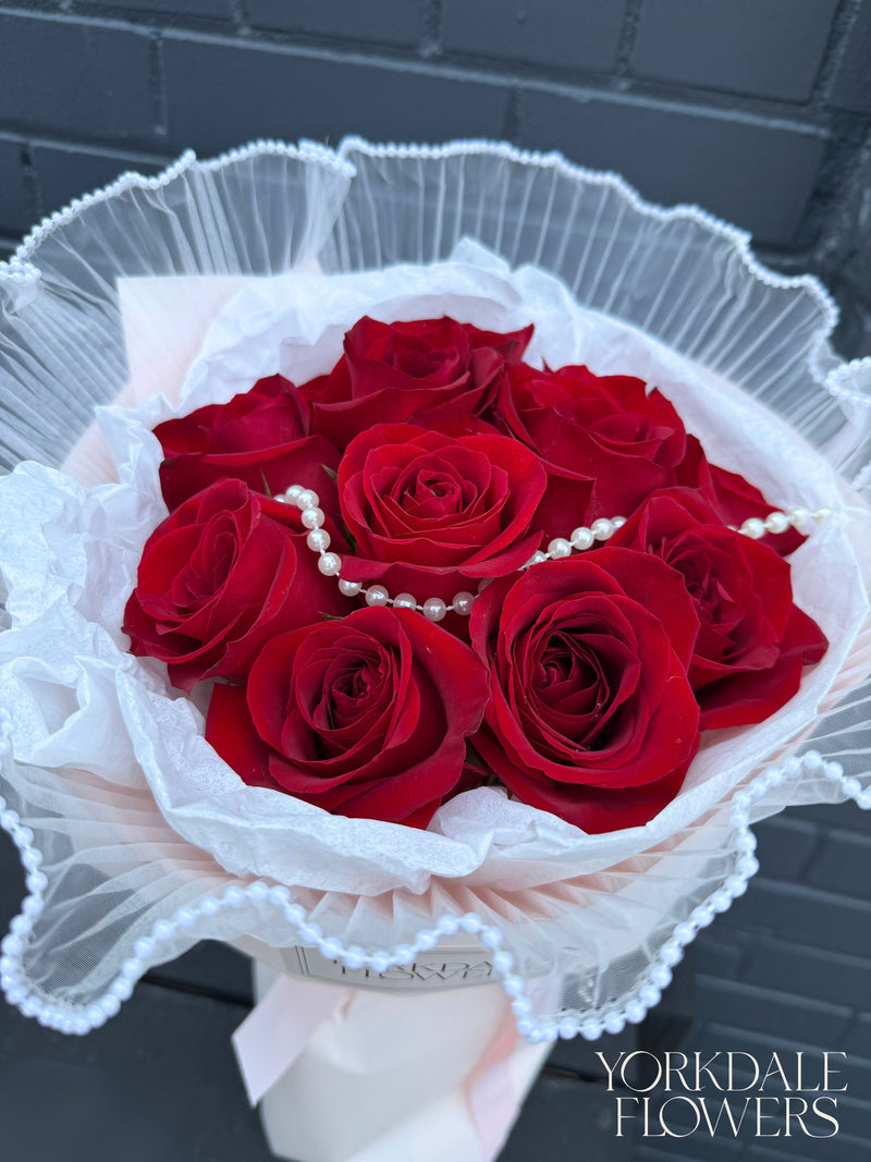 Red rose bouquet with pearl detail and pink wrapping