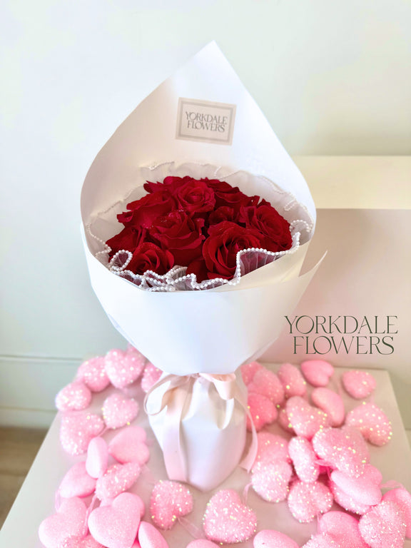 Bouquet of red roses in white wrapping
