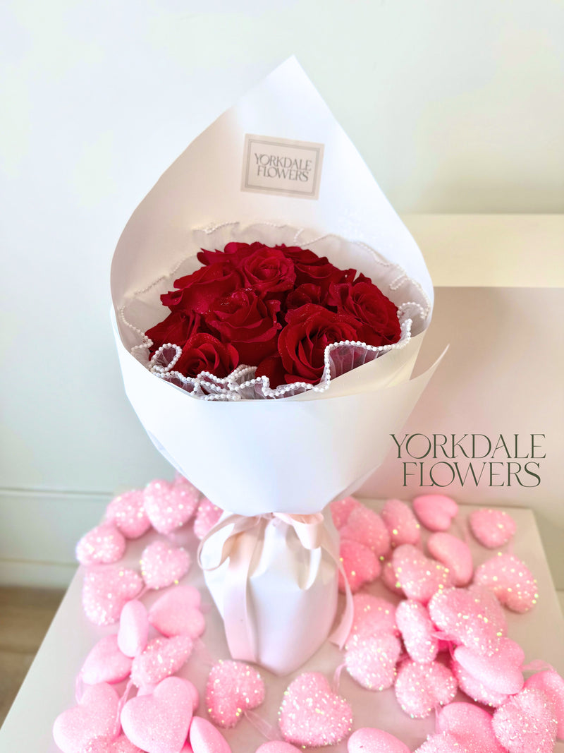 Bouquet of red roses in white wrapping