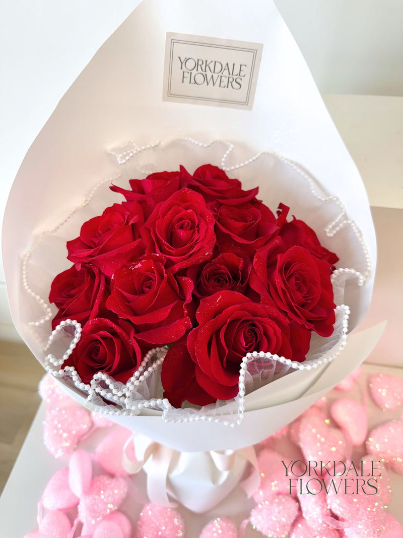 Bouquet of red roses in white wrapping