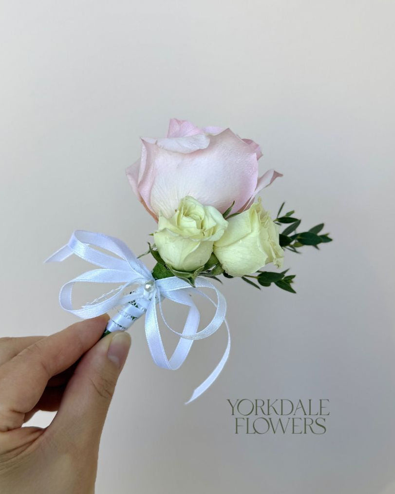 light pink rose and white mini rose boutonniere